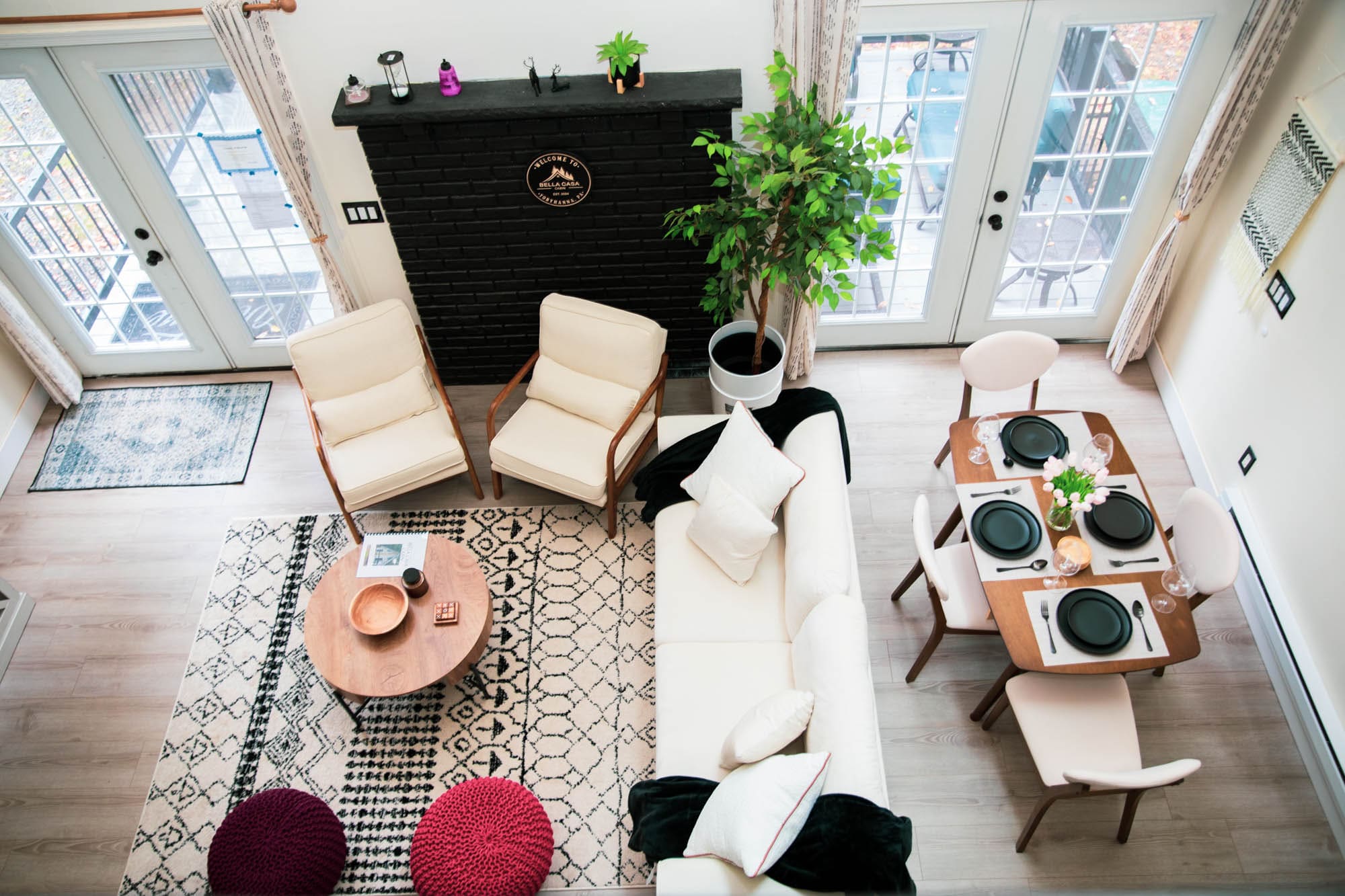 Top-down view of the cabin's living area with fireplace, sofa, and dining table